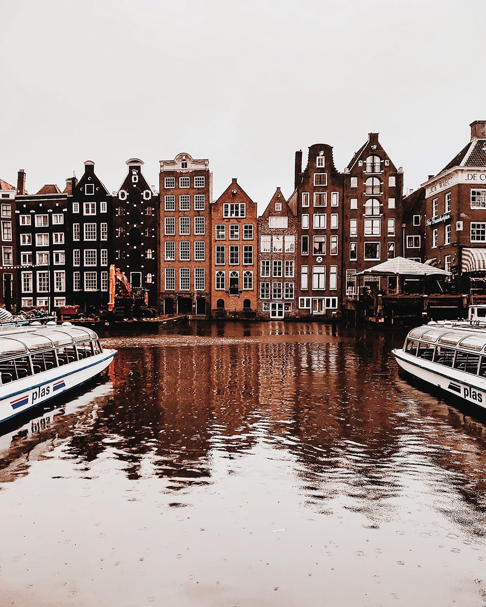 Typical dutch canal houses in Amsterdam reflected in water