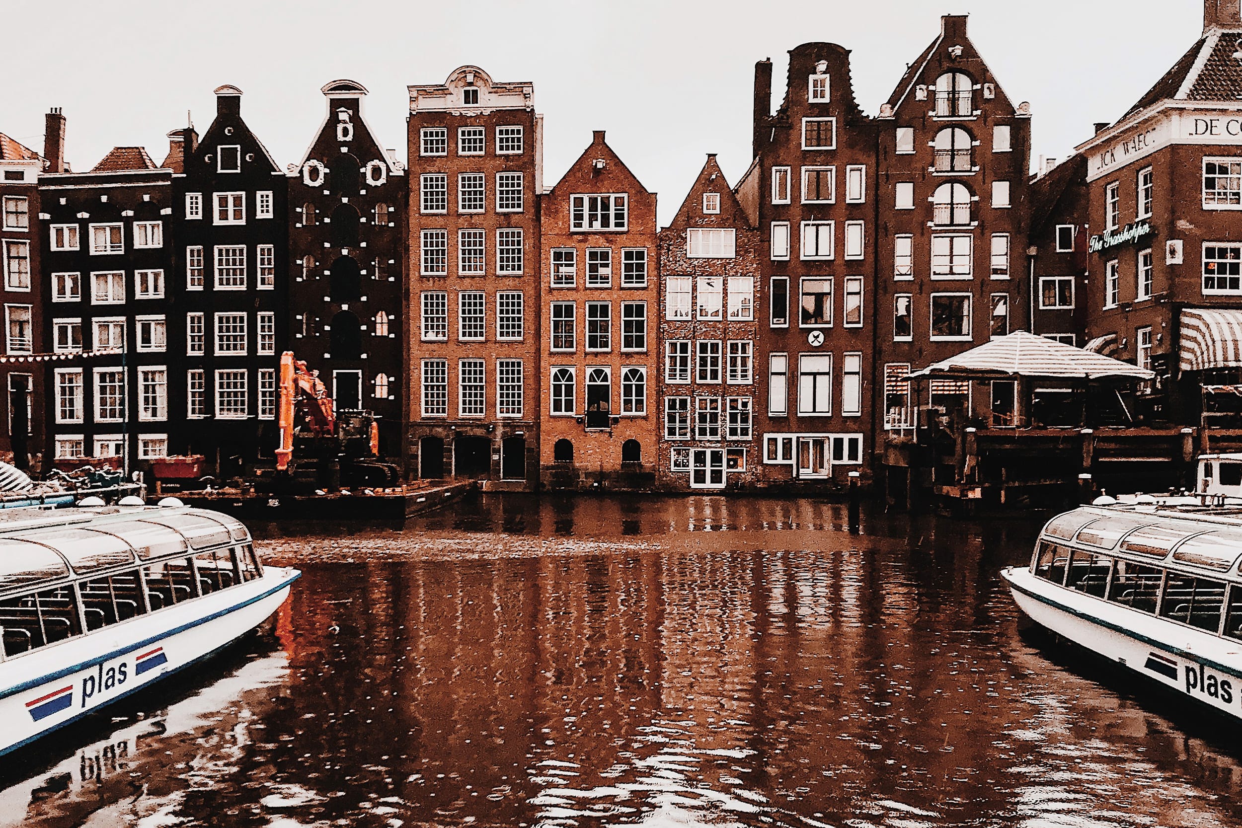 Typical dutch canal houses in Amsterdam reflected in water